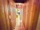 Hallway featuring natural wood paneling along the walls and hardwood flooring at 4075 Packard Ave, St Cloud, FL 34772