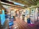 Rustic kitchen featuring wood beam ceilings, terra cotta floors, and a cozy dining area at 4075 Packard Ave, St Cloud, FL 34772