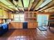 Charming kitchen with natural wood cabinets, stainless steel appliances, and rustic wood beam ceiling at 4075 Packard Ave, St Cloud, FL 34772