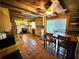 Rustic kitchen featuring wooden cabinetry, tile flooring, and a dining area with bright lighting at 4075 Packard Ave, St Cloud, FL 34772