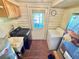 Functional laundry room equipped with a washer, dryer, utility sink, and outdoor access at 4075 Packard Ave, St Cloud, FL 34772