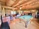 Inviting living room boasting a pool table, fireplace, beamed ceilings, and comfortable seating at 4075 Packard Ave, St Cloud, FL 34772