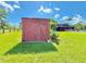 Outbuilding on a well-maintained green lawn with the home and pool in the background at 4075 Packard Ave, St Cloud, FL 34772