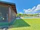 Screened patio overlooking a beautiful backyard lawn with a fenced-in pool area at 4075 Packard Ave, St Cloud, FL 34772