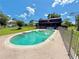 Relaxing backyard pool featuring a beautiful deck, fenced in area, and charming home at 4075 Packard Ave, St Cloud, FL 34772
