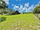 Expansive green property featuring a charming home, playground, and fenced pasture at 4075 Packard Ave, St Cloud, FL 34772