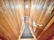 Unique wood-lined staircase with black carpet stair runners at 4075 Packard Ave, St Cloud, FL 34772