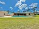 Spacious backyard with a sparkling pool, screened patio, lush grass, and a secure fence, perfect for outdoor living at 4125 Packard Ave, St Cloud, FL 34772