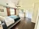Bedroom with wood-look floors, modern sliding barn door, and a closet at 4125 Packard Ave, St Cloud, FL 34772