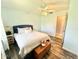 Bright bedroom with wood-look floors, a ceiling fan, and modern accents at 4125 Packard Ave, St Cloud, FL 34772