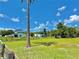 Farmhouse exterior with fenced pasture and a barn building under a bright blue sky with puffy white clouds at 4125 Packard Ave, St Cloud, FL 34772