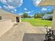 Exterior view of the home featuring a spacious, paved backyard and detached garage at 4125 Packard Ave, St Cloud, FL 34772