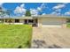 Charming single-story home with a well-manicured lawn and attached two-car garage at 4125 Packard Ave, St Cloud, FL 34772