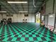 A spacious garage featuring checkerboard flooring, ample natural light, and convenient access at 4125 Packard Ave, St Cloud, FL 34772