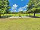 The backyard features a fenced garden area with greenery and neatly arranged plants, enhancing the outdoor space at 4125 Packard Ave, St Cloud, FL 34772