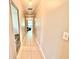 Tiled hallway leading to a room with comfortable furniture and natural light at 4125 Packard Ave, St Cloud, FL 34772