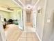Hallway featuring neutral tile flooring and light-colored walls leading to adjacent rooms at 4125 Packard Ave, St Cloud, FL 34772
