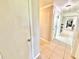 Neutral hallway with tile floor and white doors for storage and access at 4125 Packard Ave, St Cloud, FL 34772