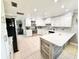 Well-equipped kitchen featuring white cabinets, stainless steel appliances, and a center island at 4125 Packard Ave, St Cloud, FL 34772