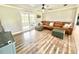 Bright living room featuring a comfortable leather sofa and hardwood floors at 4125 Packard Ave, St Cloud, FL 34772