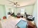 Relaxing green room featuring a ceiling fan, natural light, and a large mirrored closet at 4125 Packard Ave, St Cloud, FL 34772