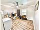 A room with wood-look flooring, a ceiling fan, and a collection of assorted items and boxes for storage at 4125 Packard Ave, St Cloud, FL 34772