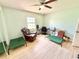 Relaxing green room with a ceiling fan, natural light from a window, and a comfortable recliner at 4125 Packard Ave, St Cloud, FL 34772