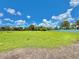 A vast, green, grassy lot under a bright blue sky dotted with fluffy white clouds at 4125 Packard Ave, St Cloud, FL 34772