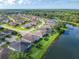 An aerial view showing homes lining the lake with mature landscaping at 418 Treviso Dr, Kissimmee, FL 34759