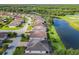 An aerial view shows homes alongside the lake and a golf course at 418 Treviso Dr, Kissimmee, FL 34759