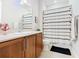 Bright bathroom featuring wood cabinets, a white countertop, and a shower with a stylish curtain at 418 Treviso Dr, Kissimmee, FL 34759