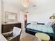 Comfortable bedroom offering a trundle bed, dresser with mirror, stylish lighting, and neutral carpet at 418 Treviso Dr, Kissimmee, FL 34759