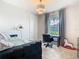 Charming bedroom featuring a desk area, stylish light fixture, and a large window with gray curtains at 418 Treviso Dr, Kissimmee, FL 34759