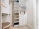 Well-organized walk-in closet featuring custom shelves, drawers, and hanging rods for maximum storage at 418 Treviso Dr, Kissimmee, FL 34759