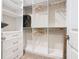 Organized walk-in closet featuring built-in shelves, drawers, and ample hanging space for clothes storage at 418 Treviso Dr, Kissimmee, FL 34759