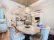 Spacious dining room open to the kitchen and living room with a chandelier at 418 Treviso Dr, Kissimmee, FL 34759