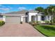 Beautiful home with a paved driveway, two-car garage, and manicured lawn at 418 Treviso Dr, Kissimmee, FL 34759
