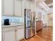 Kitchen with stainless steel appliances, granite countertops, and custom white cabinetry at 418 Treviso Dr, Kissimmee, FL 34759