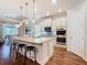 Kitchen featuring stainless steel appliances, a large island with bar seating, and pendant lighting at 418 Treviso Dr, Kissimmee, FL 34759