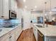 This kitchen features white cabinets, stainless steel appliances, and a large island with granite countertops at 418 Treviso Dr, Kissimmee, FL 34759