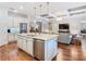 Open-concept kitchen with island and living area with coffered ceilings for seamless entertaining at 418 Treviso Dr, Kissimmee, FL 34759