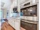 Kitchen with stainless steel appliances, custom cabinets, and mosaic backsplash at 418 Treviso Dr, Kissimmee, FL 34759