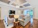 Bright living room featuring a coffered ceiling, modern lighting, and an open layout to the outside patio at 418 Treviso Dr, Kissimmee, FL 34759