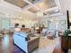 The open living room features a decorative coffered ceiling, seamlessly connecting the kitchen, dining area, and foyer at 418 Treviso Dr, Kissimmee, FL 34759