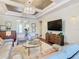 Open living room with a coffered ceiling, an entertainment center, and access to other rooms in the home at 418 Treviso Dr, Kissimmee, FL 34759