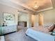 Large main bedroom with a trey ceiling, a modern chandelier, and an open doorway at 418 Treviso Dr, Kissimmee, FL 34759