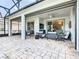Spacious outdoor patio with stone flooring, comfortable seating, and a screened-in lanai at 418 Treviso Dr, Kissimmee, FL 34759