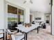 Inviting covered patio with ceiling fans, tile flooring, and views of the golf course and lake at 418 Treviso Dr, Kissimmee, FL 34759