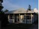 Quaint home with a metal roof, covered porch and yard at 423 Midway Ave, Mascotte, FL 34753