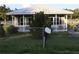 Charming single-story home featuring a white picket fence and a well-manicured lawn with mature trees at 423 Midway Ave, Mascotte, FL 34753